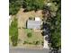 Aerial view of the home on large lot with mature trees, a detached garage and privacy at 12015 Se 72Nd Court Rd, Belleview, FL 34420