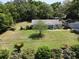 Aerial shot of a well-manicured property with a charming house and a detached two car garage at 12015 Se 72Nd Court Rd, Belleview, FL 34420