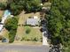 Aerial view of a home with lush greenery, pool and detached garage on a quiet residential street at 12015 Se 72Nd Court Rd, Belleview, FL 34420