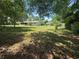 Spacious backyard with mature trees provides plenty of shade and room for outdoor activities at 12015 Se 72Nd Court Rd, Belleview, FL 34420