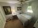 Bright bedroom with large window, neutral walls, ceiling fan and carpeted floors at 12015 Se 72Nd Court Rd, Belleview, FL 34420