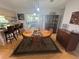 A charming dining area boasts a wood table, six chairs, and a view into a sun room at 12015 Se 72Nd Court Rd, Belleview, FL 34420