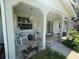 Charming front porch with rocking chairs and tasteful decor creates a welcoming entrance at 12015 Se 72Nd Court Rd, Belleview, FL 34420