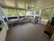 Sun room with lots of windows, natural light and comfortable seating at 12015 Se 72Nd Court Rd, Belleview, FL 34420
