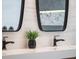 Close up of bathroom double vanity with sleek mirrors and pendant lighting at 1209 Gunnison Ave, Orlando, FL 32804