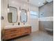 Bathroom with double vanity, sleek mirrors, pendant lights and shower at 1209 Gunnison Ave, Orlando, FL 32804