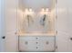 Bright bathroom features a double vanity with oval mirrors and white cabinetry at 1209 Gunnison Ave, Orlando, FL 32804