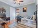 Cozy bedroom with hardwood floors, a daybed, and a built-in desk at 1209 Gunnison Ave, Orlando, FL 32804