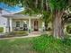 Charming home featuring a covered front porch and beautiful, mature trees and landscaping at 1209 Gunnison Ave, Orlando, FL 32804