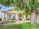 Charming home with a welcoming porch, lush landscaping, and a beautiful mature tree at 1209 Gunnison Ave, Orlando, FL 32804