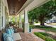 Inviting covered porch featuring brick flooring and traditional columns perfect for relaxing outdoors at 1209 Gunnison Ave, Orlando, FL 32804
