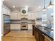 Updated kitchen with stainless steel appliances, white cabinets, and subway tile backsplash offers a modern and functional space at 1209 Gunnison Ave, Orlando, FL 32804