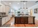 Open-concept kitchen boasts large island, stainless steel appliances, and seamless flow into the living area at 1209 Gunnison Ave, Orlando, FL 32804