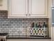Close-up of kitchen counter with marble backsplash and decorative storage basket, adding charm and organization at 1209 Gunnison Ave, Orlando, FL 32804