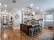 Stylish kitchen features an island with seating, stainless steel appliances, and hardwood floors, perfect for entertaining at 1209 Gunnison Ave, Orlando, FL 32804