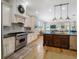 Gourmet kitchen with stainless steel appliances, custom cabinetry, island, and open to the living room perfect for entertaining at 1209 Gunnison Ave, Orlando, FL 32804