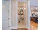 Elegant powder room with pedestal sink and decorative wallpaper at 1209 Gunnison Ave, Orlando, FL 32804