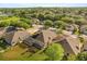 Overhead view of homes featuring a screened in pool area and lush greenery in a neighborhood at 122 Lower Lake Ct, Debary, FL 32713