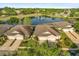Scenic aerial view of homes overlooking a serene lake with a fountain and lush green surroundings at 122 Lower Lake Ct, Debary, FL 32713