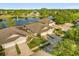 Aerial view of houses backing up to lake with fountain at 122 Lower Lake Ct, Debary, FL 32713