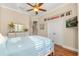 Sunny bedroom featuring stylish decor, a ceiling fan, and hardwood floors at 122 Lower Lake Ct, Debary, FL 32713