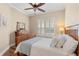 Bedroom featuring wood floors, shutters on the window, and a beautiful dresser at 122 Lower Lake Ct, Debary, FL 32713