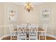 Elegant dining room with hardwood floors, a chandelier, and a wood dining table set for six at 122 Lower Lake Ct, Debary, FL 32713
