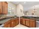 Detailed view of the kitchen showcasing granite countertops, custom wood cabinets, and tiled backsplash at 122 Lower Lake Ct, Debary, FL 32713