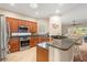 Well-lit kitchen featuring custom wood cabinets, granite countertops, and stainless steel appliances at 122 Lower Lake Ct, Debary, FL 32713