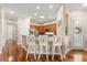 Bright and airy kitchen featuring granite countertops, bar seating, and stainless steel appliances at 122 Lower Lake Ct, Debary, FL 32713