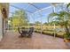 Screened lanai with lake views, featuring a patio dining set at 122 Lower Lake Ct, Debary, FL 32713