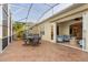 Covered lanai with outdoor dining and access to sunroom at 122 Lower Lake Ct, Debary, FL 32713