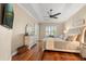 Bright main bedroom features trey ceilings, a ceiling fan, and beautiful wood floors at 122 Lower Lake Ct, Debary, FL 32713