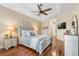 Inviting main bedroom with hardwood floors, a ceiling fan, and a cozy queen-sized bed at 122 Lower Lake Ct, Debary, FL 32713