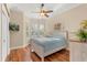 Charming main bedroom featuring hardwood floors, plantation shutters, and stylish decor at 122 Lower Lake Ct, Debary, FL 32713