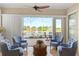 Cozy sunroom with tile floors and views of the lake and fountain at 122 Lower Lake Ct, Debary, FL 32713