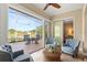 Comfortable sunroom with tile floors, fan, and views of the screened lanai at 122 Lower Lake Ct, Debary, FL 32713