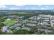 Wide aerial view of community with amenities, lush landscape, and homes at 13118 Honey Locust Dr, Orlando, FL 32828