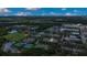 Aerial view of a neighborhood with amenities, lush landscape, and residential areas at 13118 Honey Locust Dr, Orlando, FL 32828