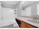 Bathroom featuring a shower and tub combination and vanity with light countertops and wood cabinets at 13118 Honey Locust Dr, Orlando, FL 32828