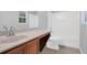 Bathroom showcasing a tub and shower combination, light countertops, and tile flooring at 13118 Honey Locust Dr, Orlando, FL 32828