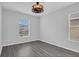 Bright bedroom with hardwood floors, a modern ceiling fan, and lots of natural light at 13118 Honey Locust Dr, Orlando, FL 32828