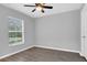 Bedroom features wood laminate floors, a ceiling fan and natural light from the window at 13118 Honey Locust Dr, Orlando, FL 32828