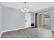 Bright dining area with modern gray floors, chandelier, a sliding glass door and neutral walls at 13118 Honey Locust Dr, Orlando, FL 32828