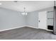 Bright dining room with modern gray floors, chandelier, and a door to the backyard at 13118 Honey Locust Dr, Orlando, FL 32828