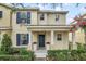 Charming two-story home featuring a welcoming entrance with blue shutters and a well-maintained landscaped yard at 13118 Honey Locust Dr, Orlando, FL 32828