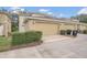 Two-car garage with ample driveway space, exterior lighting, and attractive landscaping at 13118 Honey Locust Dr, Orlando, FL 32828