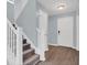 Bright hallway with staircase featuring gray carpet, white railing, and contemporary lighting fixtures at 13118 Honey Locust Dr, Orlando, FL 32828
