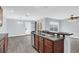 Bright kitchen with gray countertops, stainless steel appliances, wood cabinets, and breakfast bar overlooking dining area at 13118 Honey Locust Dr, Orlando, FL 32828