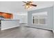 Open-concept living room with modern gray floors, connecting to the kitchen and dining areas at 13118 Honey Locust Dr, Orlando, FL 32828